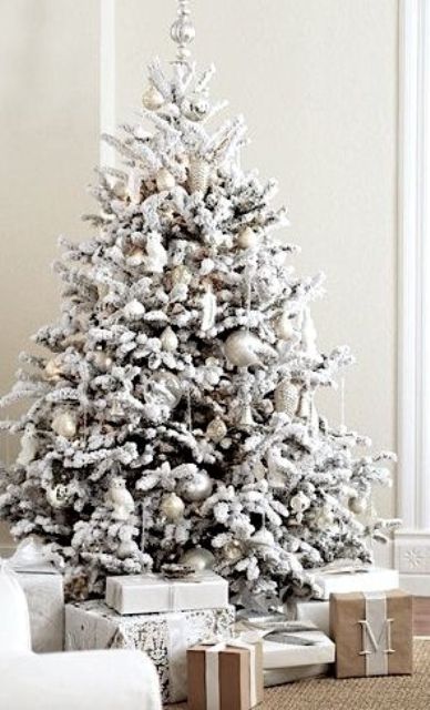 fresh and modern snowy tree with silver ornaments