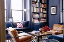 24 navy space with tan leather chairs, a brown coffee table