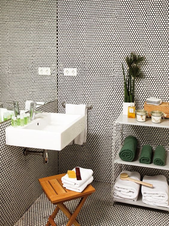 white tiles with black grout all over the bathroom