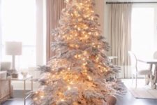 26 rock a snowy tree with only lights for an incredible holiday look