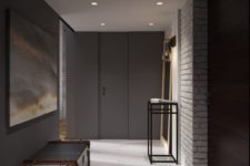 27 dark walls and white brick create a contrast in this modern entryway
