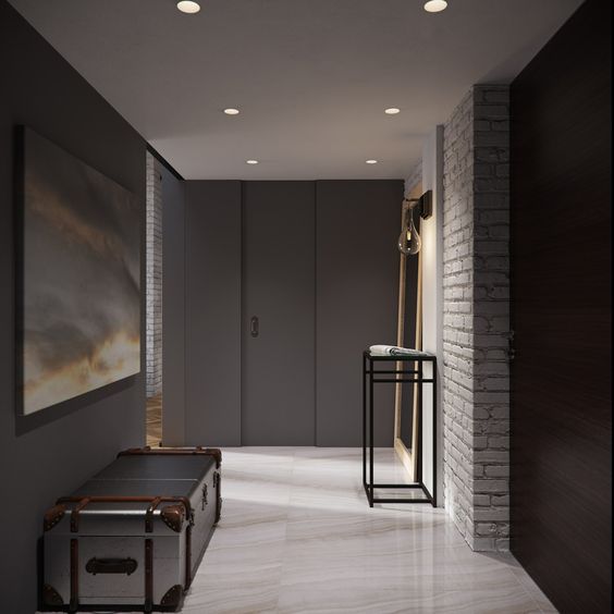 dark walls and white brick create a contrast in this modern entryway