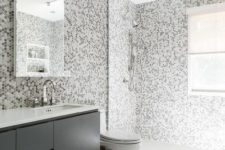 32 gray kids’ bathroom features grey hex tiles on the wall and they continue to the shower
