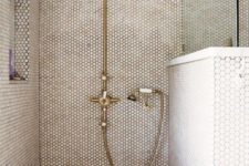34 shower with creamy penny tiles, touches of marble and brass fixtures
