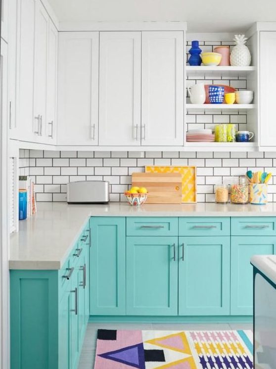 a cheerful turquoise and white kitchen with white subway tiles, colorful accessories and rugs for a fun feel