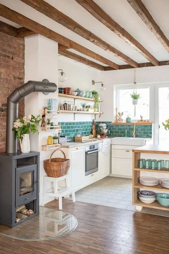 a modern country kitchen with white walls and white cabinetry, wooden beams on the ceiling, a hearth and a basket plus wooden shelves