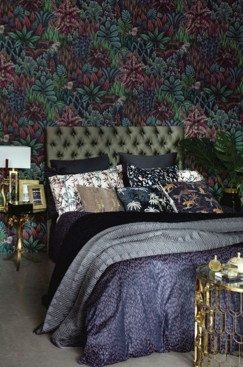a moody and refined maximalist bedroom with a dark floral wall, a green upholstered bed, printed bedding, gilded touches for more elegance 25+ Romantic Dark & Cozy Bedroom Ideas