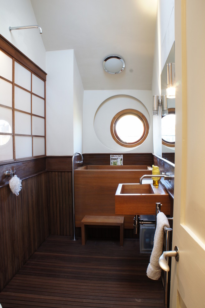 a wooden bathtub, a wooden sink and wood on walls and floors make any bathroom cozy (Chris Dyson Architects)