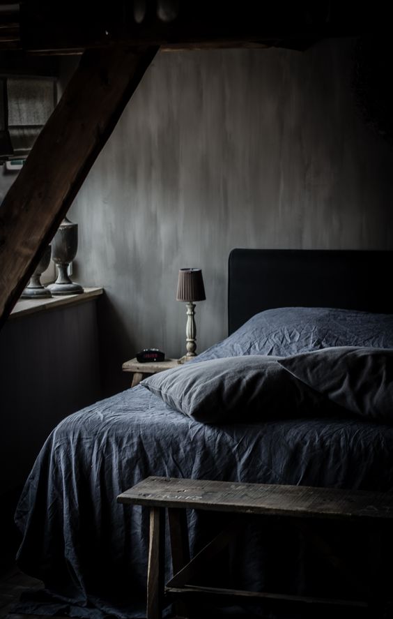 moody bedroom with textural walls and vintage finds from a flea market