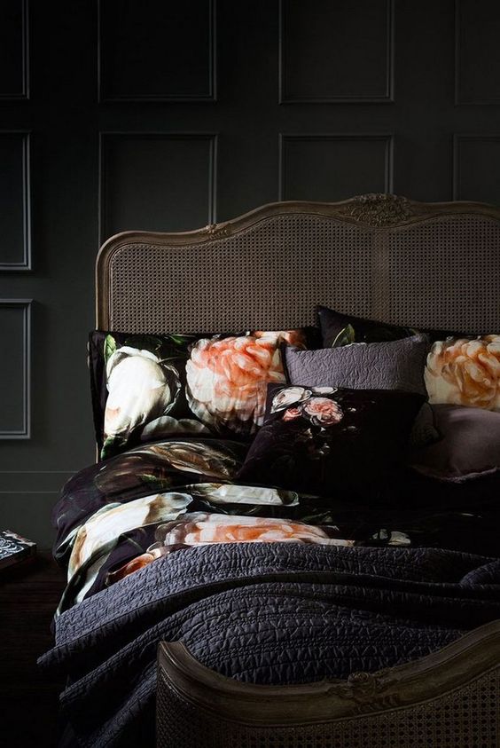 refined black bedroom with an antique bed and floral bedding