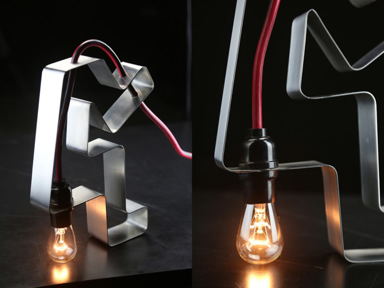 industrial lamp The piece is made of stainless steel and a red cord with a bulb, it features industrial design