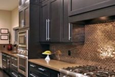 02 black kitchen with copper tile backsplash looks bold and chic