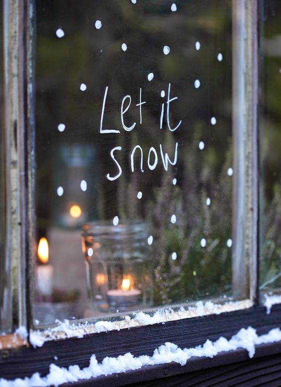 window decorated with white paint and words from a famous song