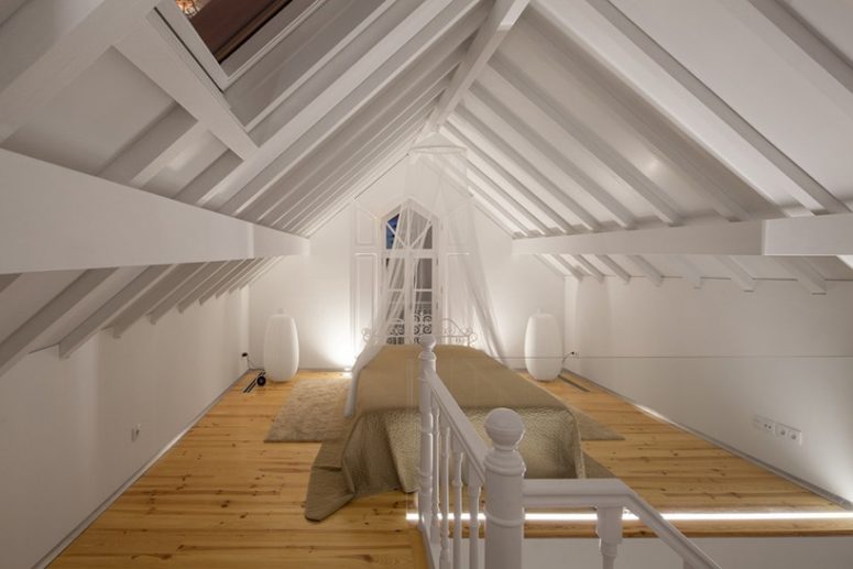 The master bedroom reminds of vintage decor with its vignette headboard and a canopy but looks modern also