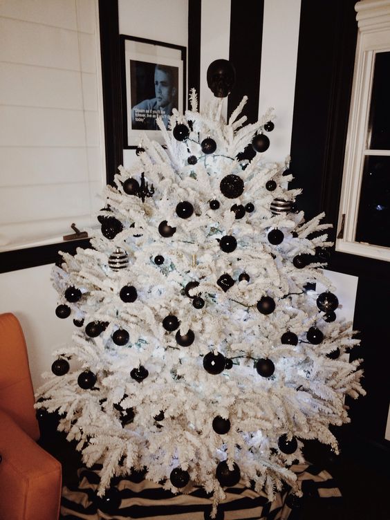 a crispy white tree with black matte and glossy ornaments