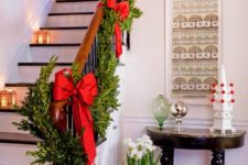 03 boxwood garland with red bows and lanterns on the stairs