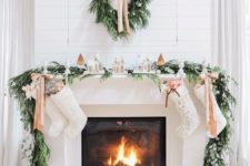 03 evergreen garland and wreath, bows and small houses make the fireplace very cozy