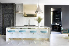 04 The kitchen island doubles as a breakfast zone and cheers up with gold touches and lucite chairs