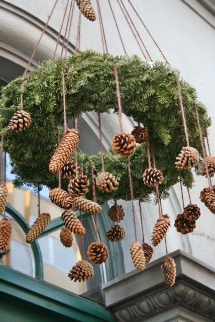 a simple evergreen wreath with hanging pine cones