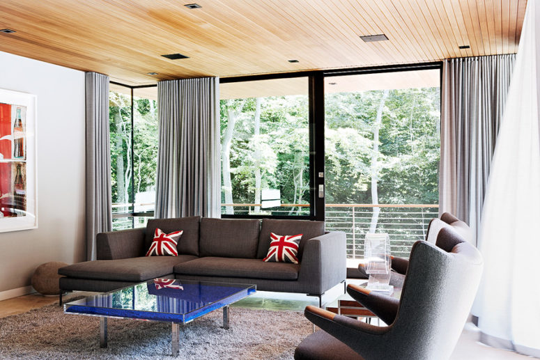 Another sitting room is decorated in dove grey and blue, with extensize glazings that offer calming views Another sitting room is decorated in dove grey and blue, with extensize glazings that offer calming views