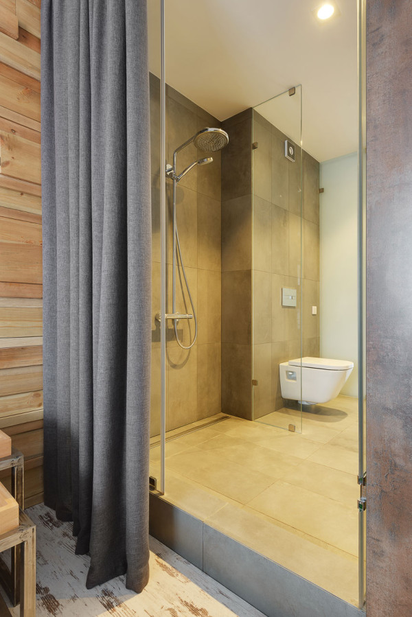 The bathroom has a walk in shower and is hidden with a curtain from the bedroom to keep it more private The bathroom has a walk-in shower and is hidden with a curtain from the bedroom to keep it more private