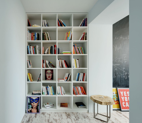 A large floor to ceiling bookshelf is placed between two areas, so it doesn't take necessary floor space in the two main zones A large floor to ceiling bookshelf is placed between two areas, so it doesn't take necessary floor space in the two main zones