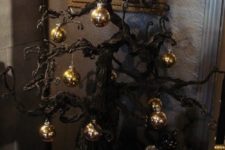06 Gothic black Christmas tree with gold ornaments for a spooky holiday