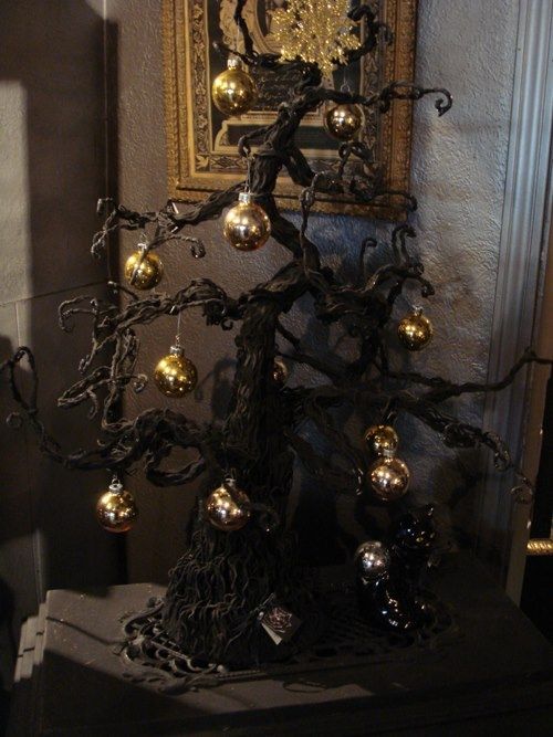 Gothic black Christmas tree with gold ornaments for a spooky holiday