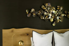 06 The focal point of the bedroom is a metallic wall art and its black and gold combo is refined