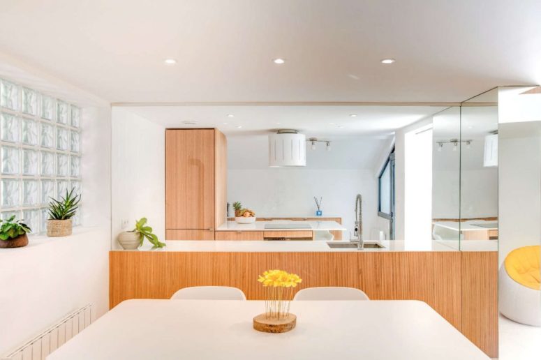 The kitchen is light filled, with warm and light wood cabinetry that keeps the look modern yet inviting and cozy The kitchen is light-filled, with warm and light wood cabinetry that keeps the look modern yet inviting and cozy