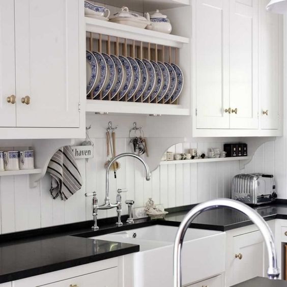 simple white beadboard backsplash contrasts with a black countertop