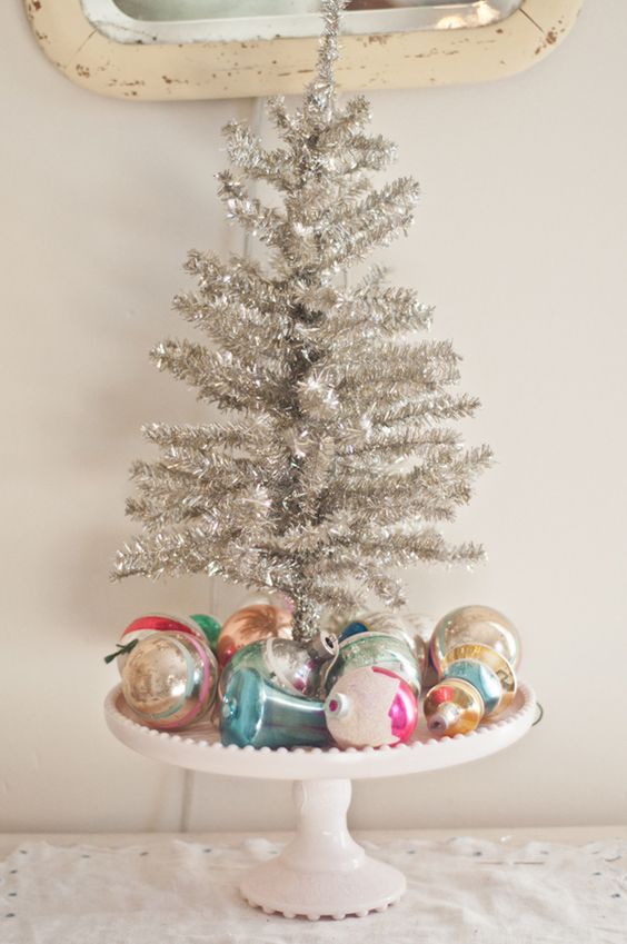 vintage Christmas display with colorful ornaments and a tinsel tree