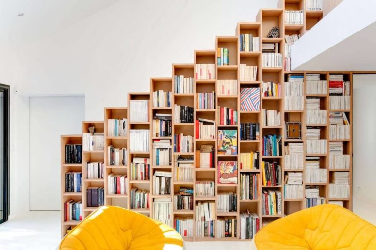 A bookshelf instead of a railing is a brilliant idea to divide spaces