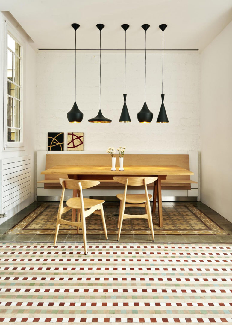 The dining space here has a wall mounted bench, s table and chairs of the same wood, mosaic tule floors and gorgeous black lamps The dining space here has a wall-mounted bench, s table and chairs of the same wood, mosaic tule floors and gorgeous black lamps