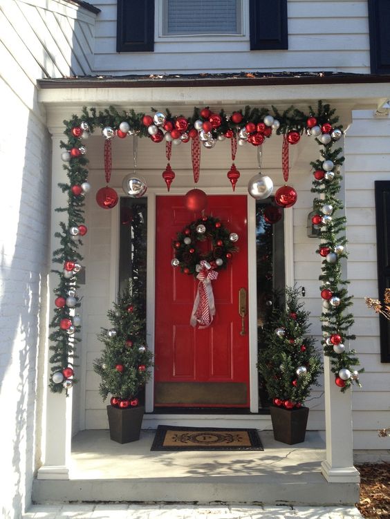 an evergreen garland and wreath with ornaments