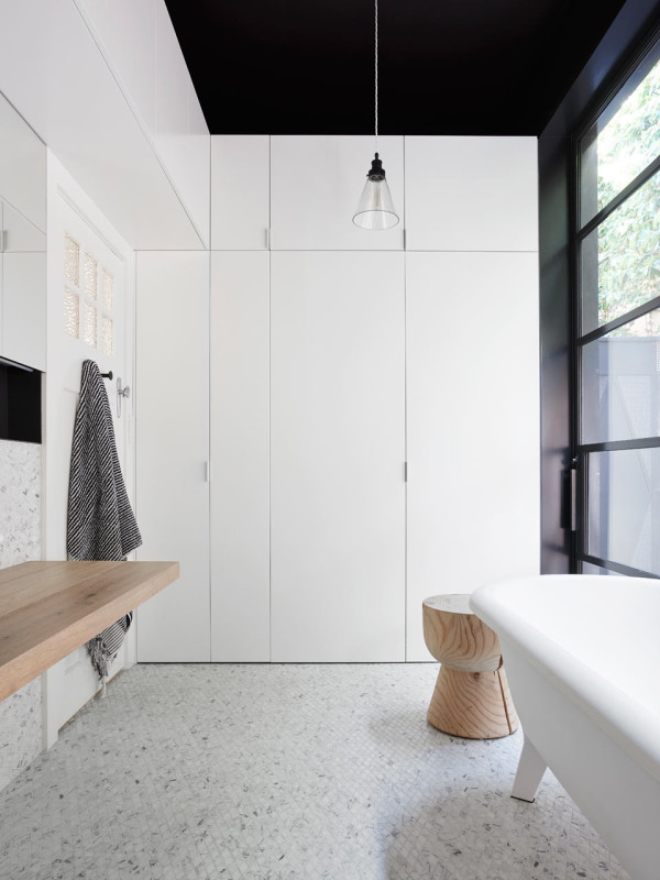 The main bathroom is a laundry room, too, but everything is hidden behind the folding doors for a sleek uncluttered look