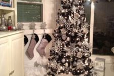 10 a black tree covered with silver ornaments all over for a bold glam look