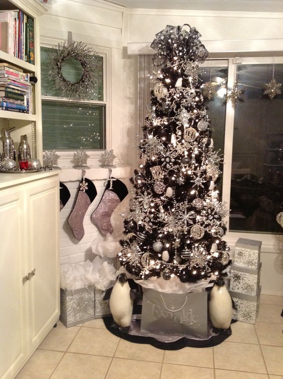 a black tree covered with silver ornaments all over for a bold glam look
