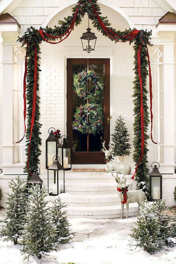 evergreen garlands, trees and wreaths with pinecones and velvet ribbon
