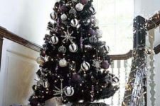 11 a black tree with white and purple decor looks non-traditional and fresh