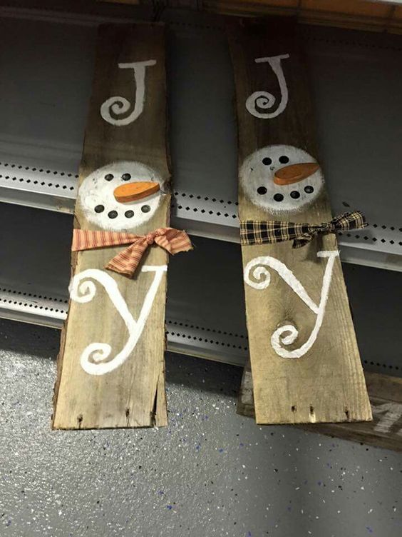 JOY wooden signs with snowmen can be hung symmetrically on each side of the door