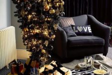 14 a black upside down Christmas tree with black and gold decor