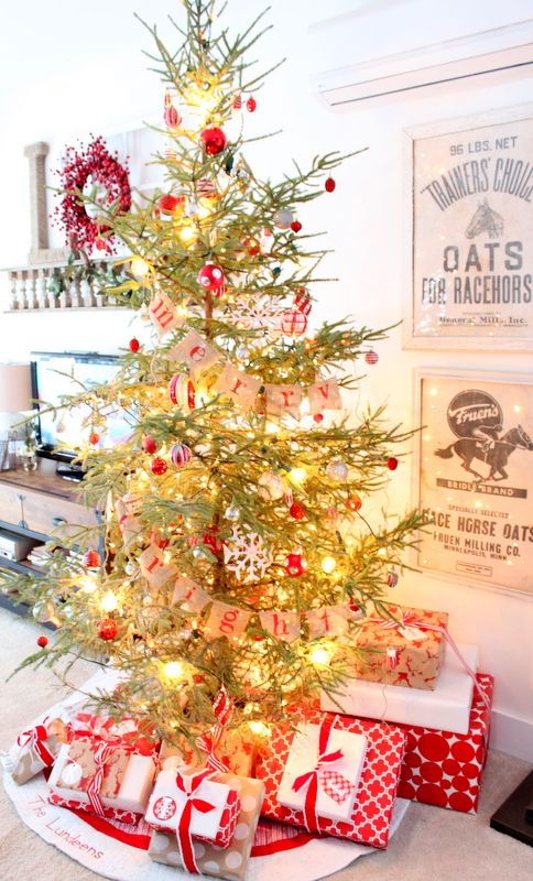 not only ornaments or buntings makeup tree decor but also stylized gift wrapping, here red and white