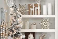 15 a flocked tree with silver ornaments, white and silver decor are soothing