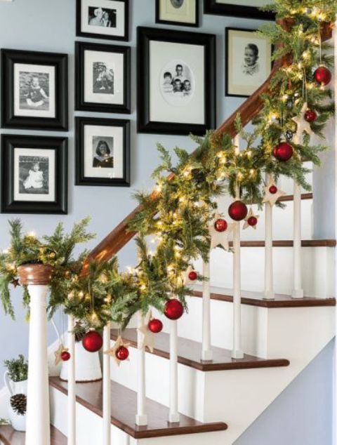 fir garland with lights and red ornaments hanging