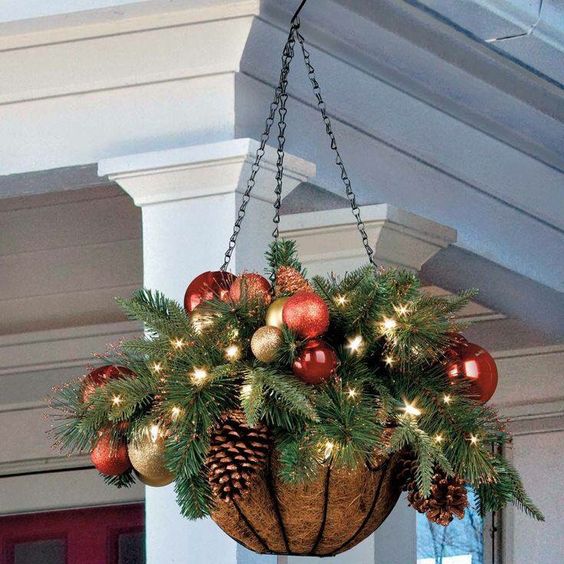 a hanging arrangement wwith ornaments, lights and evergreens