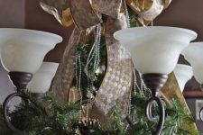 19 gold and silver ribbon, evergreen branches with pinecones to cover a chandelier