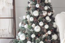 19 peaceful-looking Christmas tree with silver baubles, pinecones and burlap mesh