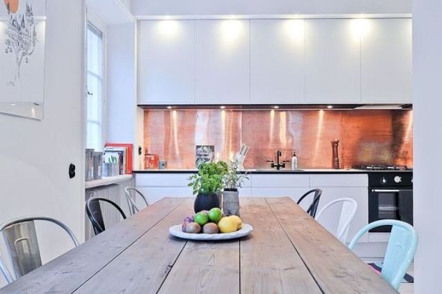 minimalist white kitchen with a polished copper backsplash