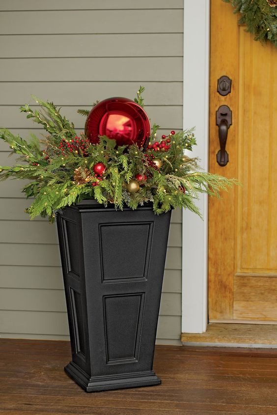 simple urn filled with evergreens, berries and ornaments